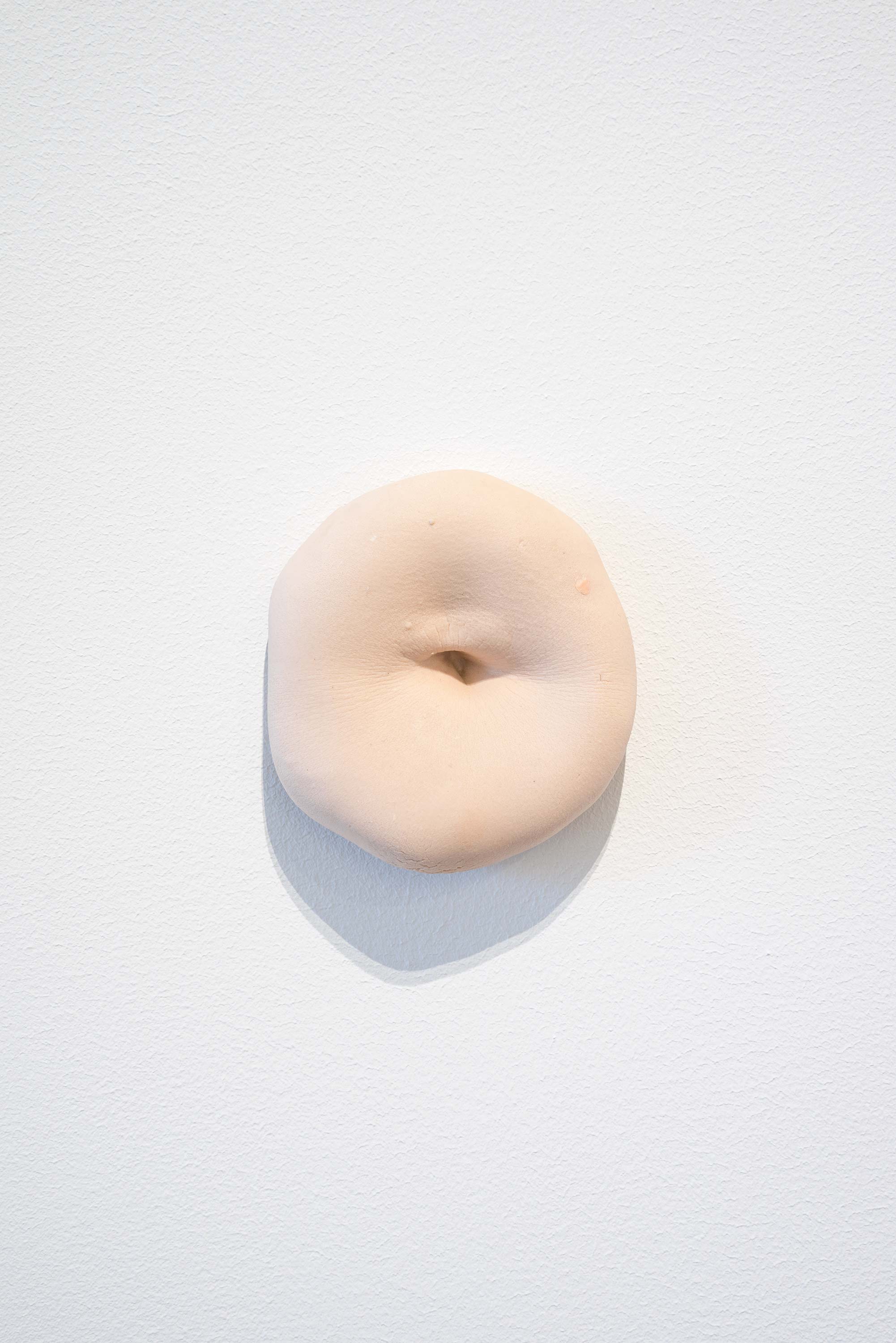 Kylie Lockwood<br>Cast of Navel<br>2013<br>Pigmented porcelain<br>3.5 x 3.25 x 1.25 inches (9 x 8.3 x 3.2 cm)