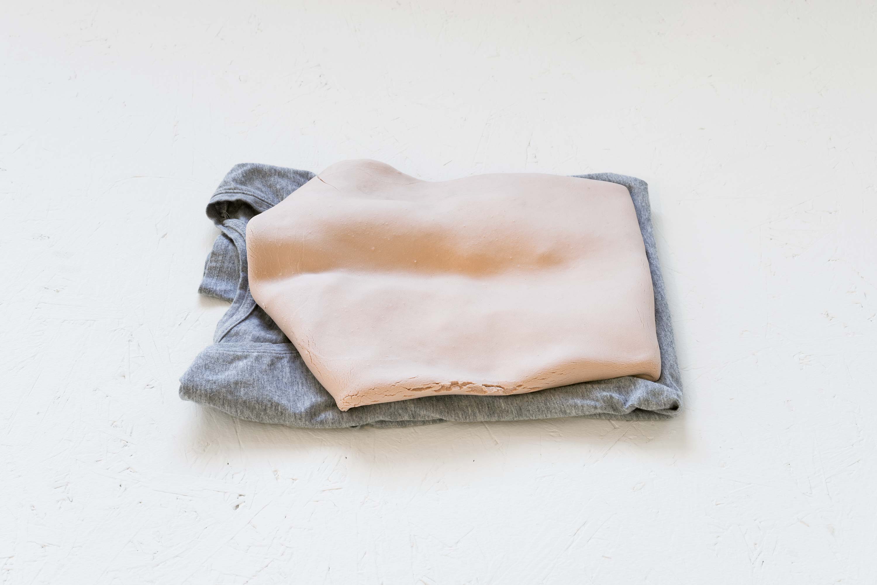 Kylie Lockwood<br>Folded<br>2013<br>Pigmented porcelain and cotton t-shirt<br>2.5 x 11 x 14 inches (6.4 x 28 x 35.6 cm)