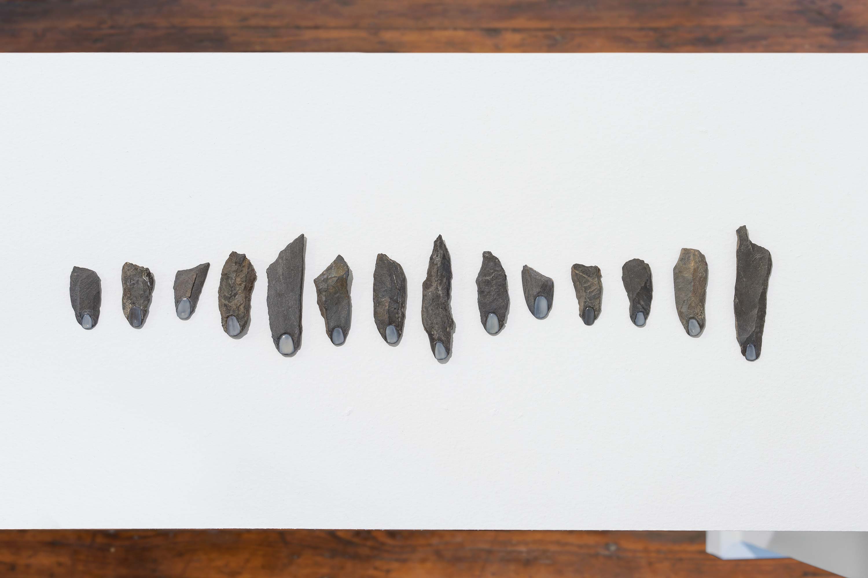 Kylie Lockwood<br>Stone Fingers<br>2013<br>River stone and nail polish<br>dimensions variable
